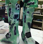 Green prosthetic leg with skull graphics